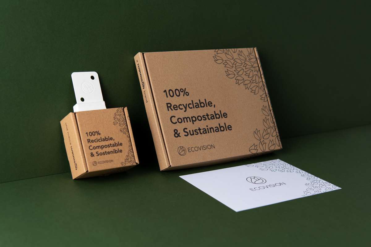 Ecovision packaging designs propped against a green background