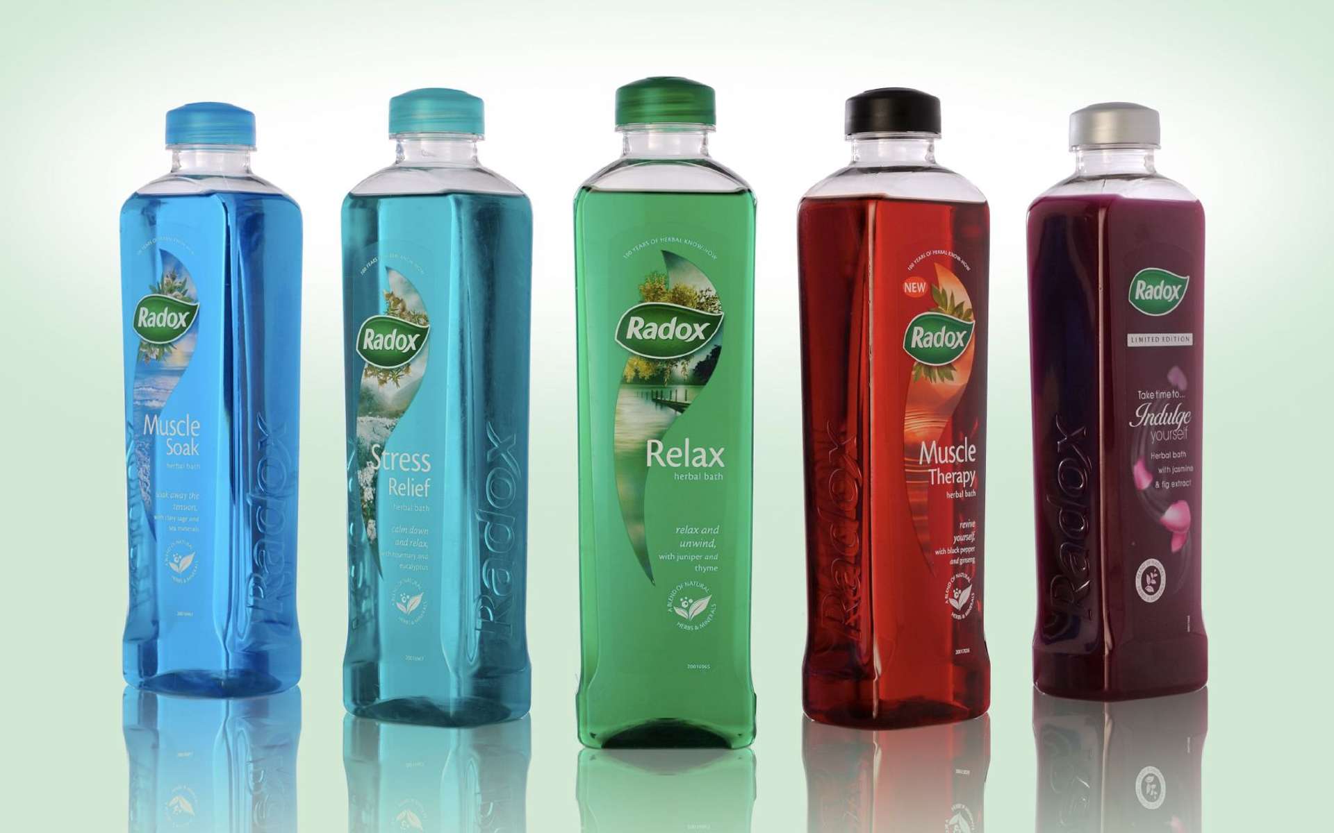 Radox bottles in a line on a green background