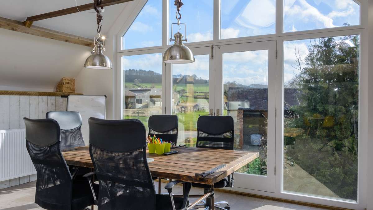 A view of the Ergo meeting table with views outside to the countryside and rolling hills