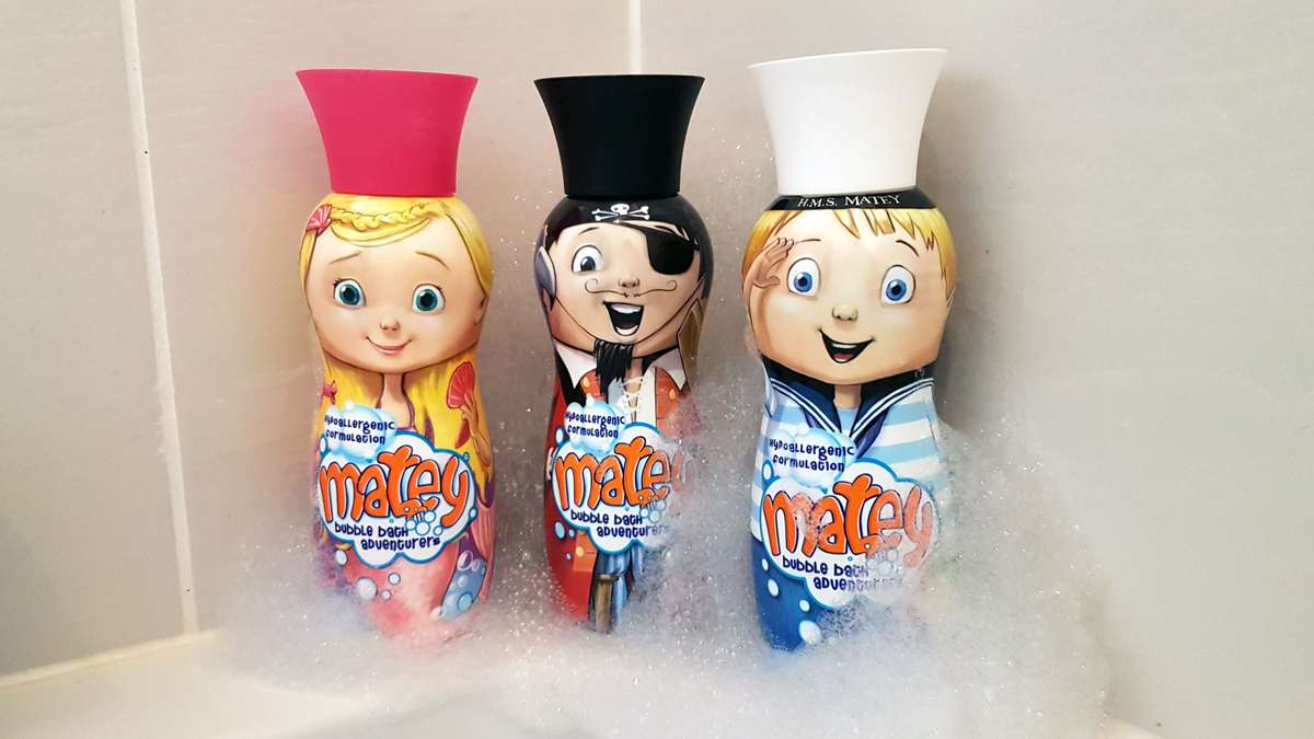 Matey bottles on edge of bath with bubbles