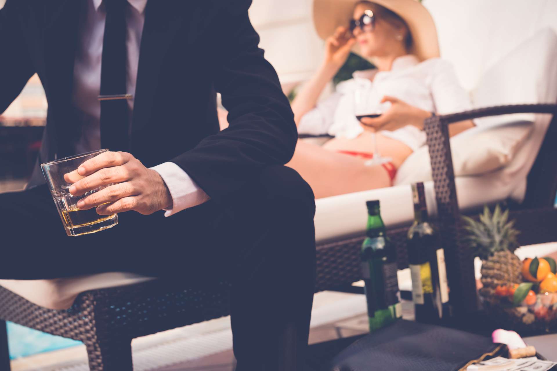 Couple Lounging in Luxury with High End alcohol