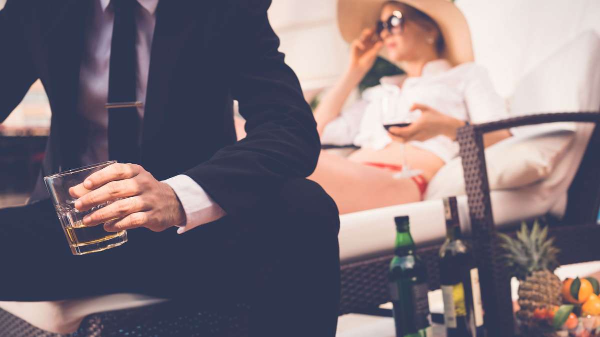 Couple Lounging in Luxury with High End alcohol