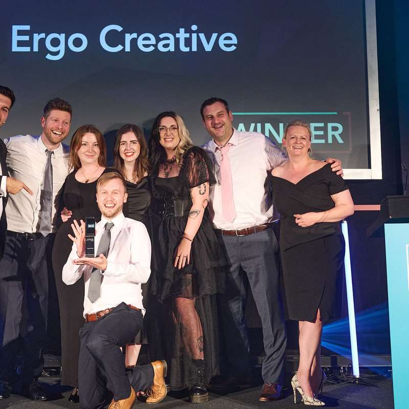 The Ergo team on stage accepting their award for best creative design agency 2023